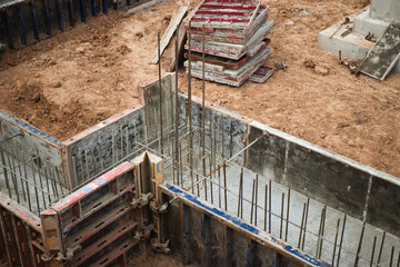 Reinforced concrete blocks are being carefully arranged and laid out on a bustling construction site