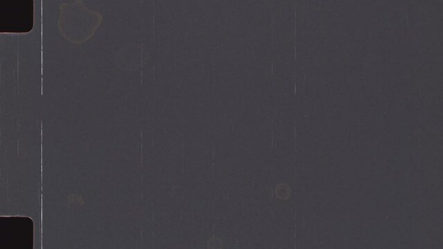 Vintage looping film strip background. Super 8 mm Film grain Dust and Scratches. Retro template. Video tape texture overlay with scratches and smudges	
