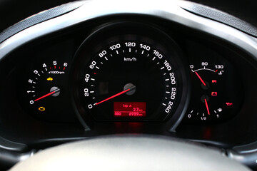 Close up Car dashboard with lights symbols. A close-up of the speedometer and tachometer.