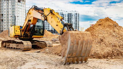 Large crawler excavator at the construction site. Close-up of an excavator bucket with the boom...