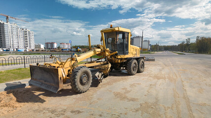 Powerful construction grader at the construction site. Grader for land planning close-up....