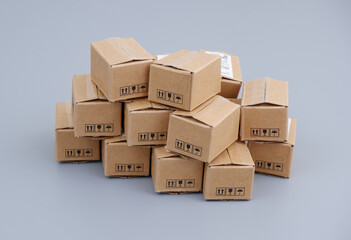 Many shipping carton boxes on gray background. Trading, shipping and delivery concept.