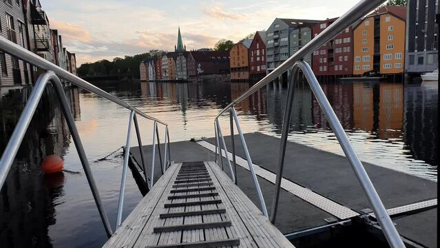 Line of timber buildings on the riverbank of Nidelva in Trondheim, Norway