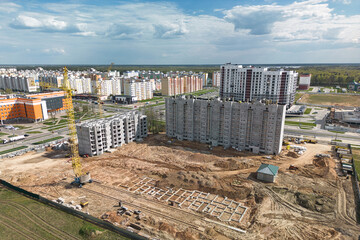 A vibrant tapestry of progress unravels below as cranes dance amidst a labyrinth of steel,...