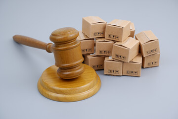 Trade laws, taxes and court concept. Judge gavel and many carton boxes on gray background.
