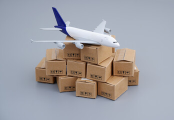 Transportation, delivery and global trading concept. Airplane on heap of carton boxes.