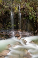 Vertical shot of the flowing rocky waterfall in Peneda-Geres National Park in Portugal