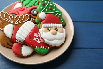 Different tasty Christmas cookies on blue wooden table, above view. Space for text