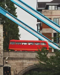 Sierkussen Classic red bus on a bridge in London, UK © Wirestock