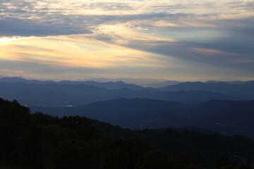 Aerial view of a beautiful forest near the mountains at sunset