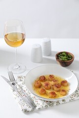 Delicious fried scallops served on white table