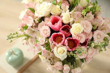 Beautiful bouquet of fresh flowers on table indoors, closeup