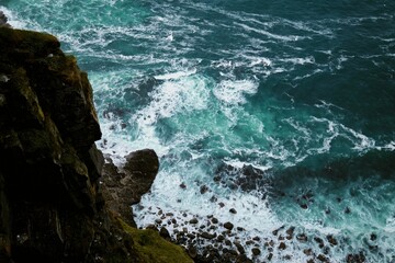 Scenic view of the evergreen Cliffs of Moher in Ireland on a gloomy day