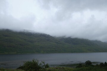 Beautiful landscape over Connemara Lake and mountains in Ireland on a foggy day