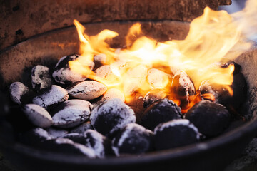Barbecue briquette background. Setting fire to coal. Blowing flame to light up the bbq. Perfect...