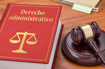 A law book with a gavel - Administrative law in spanish - obrazy, fototapety, plakaty