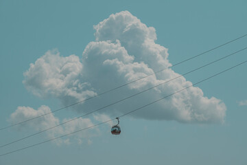 Cable car in the sky with big clouds