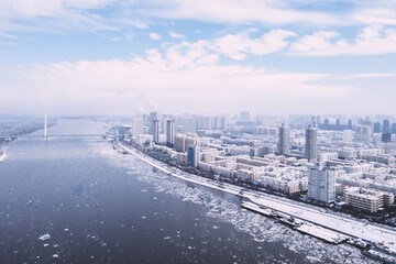 Beautiful view of a snowy city with a frozen lake