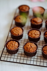 fresh muffins cooling on a baking rack, carrot muffins