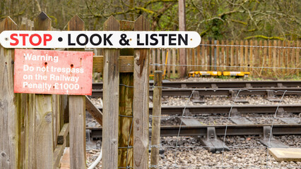 stop look listen sign, warning the public to be aware when crossing a rail way line, transport rail station concept