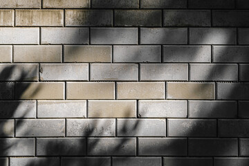 Shot of a wall of gray concrete blocks with dirt on them, vignette of shadows from tree branches, background, full frame, seamless pattern, ten (10) rows of blocks - Powered by Adobe