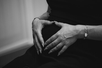 pregnant woman. health pregnancy motherhood procreation concept. close-up belly of a pregnant woman. woman waiting for indoors a newborn baby.