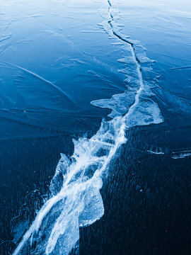High angle view of cracked frozen lake during winter