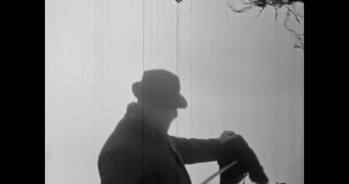Imitation, terrible maniac knife cutting off man head, lifting up. Scary horror scene background. Halloween creepy cinematic video. Evil murderer man. Vintage black white film. Retro archive 1980s
