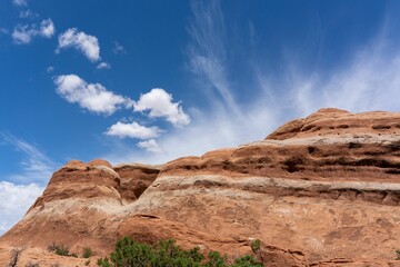 Fototapeta premium Rock formation mountain at the Arches National Park with blue cloudy sky in Utah - USA