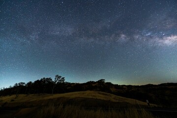 Beautiful starry sky over the hills and trees.