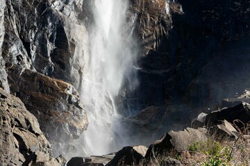 Waterfall flowing down the crag on a sunny day outdoors