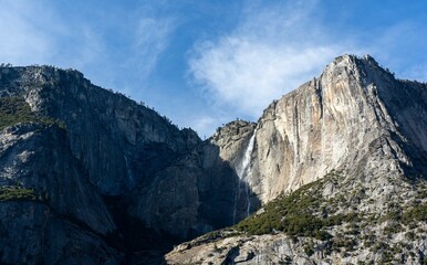 Scenic cliff under the sunlight reflection with a blue sky in the background