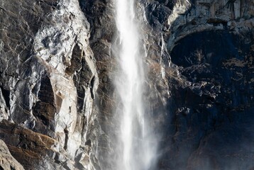 Waterfall flowing down the crag on a sunny day outdoors