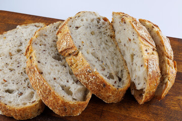 Loaf of bread cut into pieces isolated on a white background. pieces of bread. Art bread.