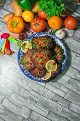 View of the delicious food in the plate and vegetables on the table