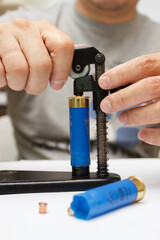 A man make repairing of plastic case for making a cartridges for shooting