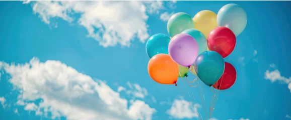 Foto op Plexiglas Colorful balloons flying in the sky, colorful balloon bouquet in front of blue sky with white clouds, commercial photography, closeup shot, high resolution, high quality © Moon Art Pic