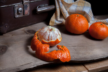 Fresh orange ripe mandarins or tangerines on wooden board.