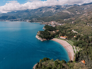 Royal beach on the shore of the Bay of Kotor near Villa Milocer. Montenegro. Drone