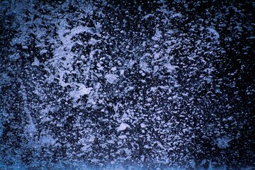 an image of a snow covered wall with water droplets on it
