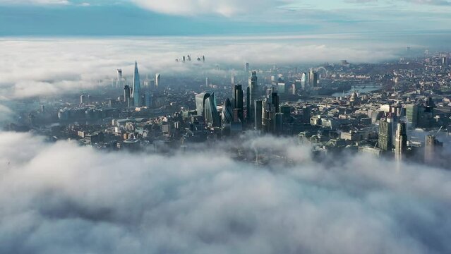 Aerial Drone view of London City above the clouds and fog