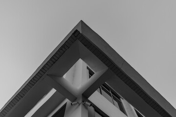 Low angle grayscale of a part of a building roof with cameras fixed on it