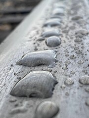 Fototapeta na wymiar Closeup of water drops on the railroad track.