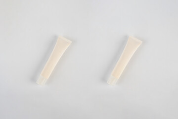 Plastic white tube for cream or lotion. Skin care or sunscreen cosmetic on white background.