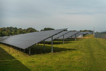 Naklejka premium Solar system panels in the large photovoltaic power plant in the green field