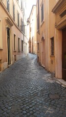 Vertical shot of a narrow alley in San Gimignano, Italy - obrazy, fototapety, plakaty