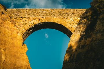 Stone arch with blue sky on the background