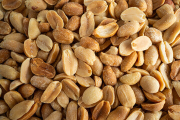 Close-up of salted shelled peanuts, ideal for food and snack enthusiasts.
