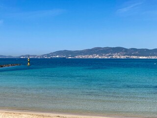 Fototapeta na wymiar Coastal town in distance and blue sea in the Balearic Islands, Mallorca, Spain