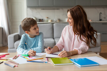 Fototapeta premium Mother and son talking and drawing together